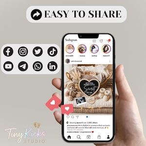 May include: A smartphone displays an Instagram post announcing a baby's arrival, with a heart-shaped sign reading "We've been keeping a little secret." The image includes baby shoes, a teddy bear, and social media icons.
