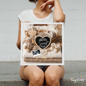 May include: A framed pregnancy announcement with a stack of folded blankets, a teddy bear, baby booties, and a sonogram. A heart-shaped chalkboard reads "We've been keeping a little secret, due June 2024." A small wooden sign says "Baby Anderson."