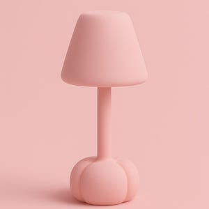 May include: A soft pink table lamp with a mushroom-like design. The lamp features a conical shade, a slender stem, and a rounded base with petal-like details. The lamp is made of a matte material and is set against a matching pink background.