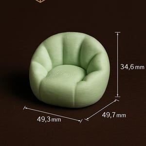 Puede incluir: Una silla redondeada de color verde claro con una superficie texturizada. La silla mide 49,7 cm de ancho, 49,3 cm de profundidad y 34,6 mm de alto. El texto "LumaLab3D" est&aacute; presente.