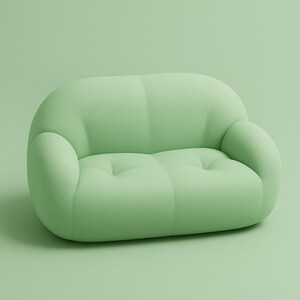 May include: A light green, two-seater sofa with a rounded, cloud-like design. The sofa has a soft, textured appearance and features a button-tufted seat. The arms are curved and integrated into the overall shape, creating a cohesive and modern aesthetic.