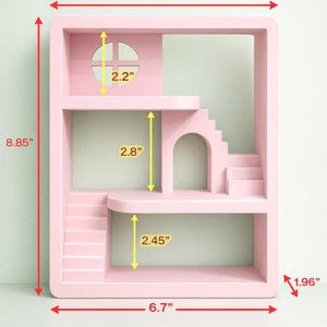 May include: A pink dollhouse-style shelf unit with multiple levels, stairs, and an arched doorway. The unit is 6.7 inches wide, 8.85 inches tall, and 1.96 inches deep. It features a window with a cross design and a rounded top.