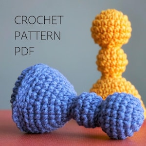 May include: A blue and yellow crochet pattern PDF. The image shows two handmade crochet objects: a blue dumbbell-shaped toy and a yellow, three-tiered decorative item. The text "CROCHET PATTERN PDF" is displayed in black.