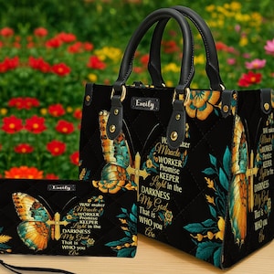 May include: Black quilted handbag and matching wallet set. The set features a butterfly and cross design with the text "WAY maker, Miracle, WORKER, Promise, KEEPER, Light in the DARKNESS, My God, That is WHO you Are".