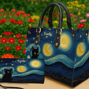 May include: A handbag and wallet set with a starry night design and a black cat motif. The bag has black handles and gold-tone hardware. The wallet includes a wrist strap. The name "Emily" is printed on both items.