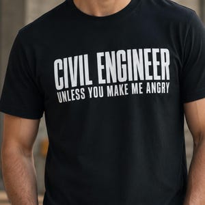 May include: A black short-sleeved t-shirt featuring white text that reads CIVIL ENGINEER UNLESS YOU MAKE ME ANGRY. The shirt has a crew neckline and a standard fit, displaying the bold lettering clearly across the chest area of the garment.
