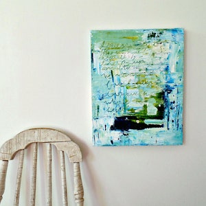 May include: Abstract painting on canvas with blue, green, and white paint. The painting has a textural surface and includes handwritten text in black.