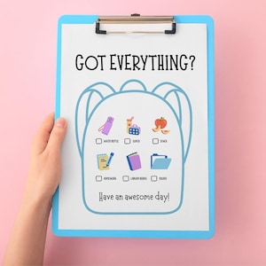May include: A blue clipboard with a checklist for school supplies, including a water bottle, lunch, and homework. The text "GOT EVERYTHING?" and "Have an awesome day!" are displayed in black. The background is pink.