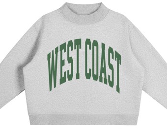 May include: A light grey long-sleeve sweatshirt featuring a mock neck collar and ribbed cuffs. The centre of the chest displays the text WEST COAST in a large, arched, dark green collegiate-style font with a bold, block-letter appearance.