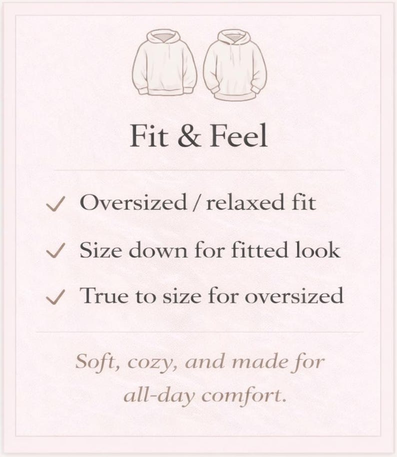 May include: A cream-colored graphic with illustrations of two hoodies and text describing the fit and feel. The text includes "Oversized / relaxed fit", "Size down for fitted look", and "True to size for oversized". The bottom text reads "Soft, cozy, and made for all-day comfort."
