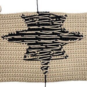 Modern crochet wall hanging pattern featuring a bold black eight-pointed star on a neutral background. This is a digital PDF pattern for instant download, not a finished product.
