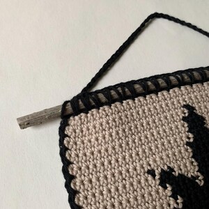 Modern crochet wall hanging pattern featuring a bold black eight-pointed star on a neutral background. This is a digital PDF pattern for instant download, not a finished product.