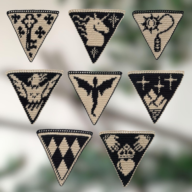 May include: A collection of seven handmade, triangular crochet patches. Each patch features a unique black design on a tan background, including a key, a unicorn, and a winged figure. The patches are bordered with a black crochet stitch.