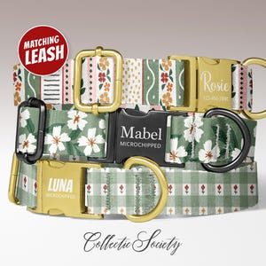 May include: Three dog collars with floral and geometric patterns. The top collar has a floral and stripe design, the middle one has white flowers, and the bottom one has a gingham pattern. Each collar has a gold buckle and a black or gold D-ring. The top collar says "Rosie".