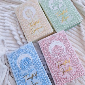 May include: Four rectangular books with pastel covers featuring floral line art and gold foil text. The books are titled Twisted Games, Twisted Love, and Twisted Hate, each decorated with a tulip, lily, sunflower, or rose illustration.