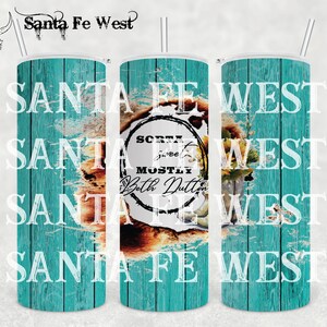 May include: A turquoise and brown tumbler with the text "Santa Fe West" and "Sort of sweet mostly Beth Dutton" in a circle.