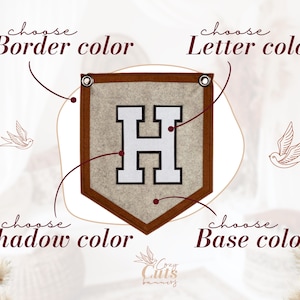 May include: A custom felt banner with a brown border, a beige base, and a white letter "H". The banner features the text "choose Border color", "choose Letter color", "choose Shadow color", and "choose Base color". Decorative bird illustrations are also present.