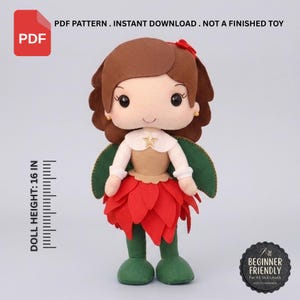 May include: A PDF pattern for a felt doll featuring brown hair, a cream-colored top with a gold star, green wings, and a red petal-style skirt. The doll stands 16 inches tall. Text includes PDF PATTERN, INSTANT DOWNLOAD, NOT A FINISHED TOY.
