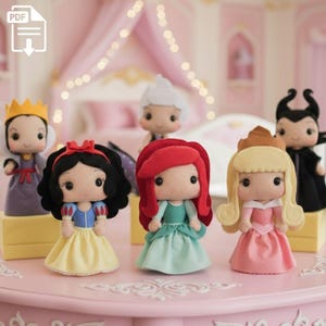 May include: A collection of handmade felt dolls depicting various fairytale characters. The dolls feature detailed costumes and accessories, including crowns, dresses, and distinctive hairstyles. The dolls are displayed on a pink surface, with a soft-focus background.