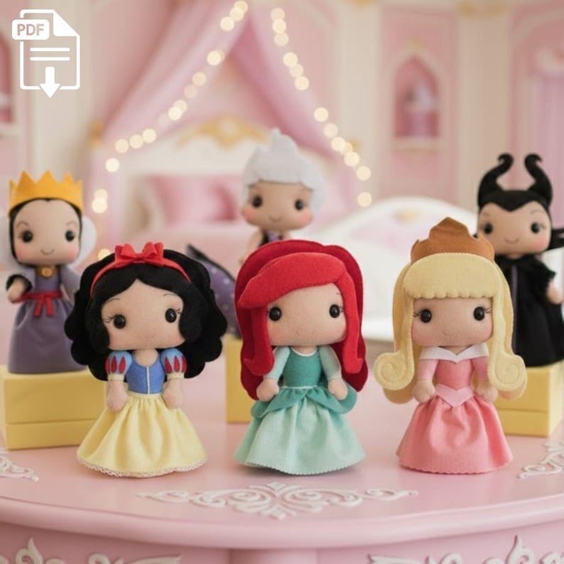 May include: A collection of handmade felt dolls depicting various fairytale characters. The dolls feature detailed costumes and accessories, including crowns, dresses, and distinctive hairstyles. The dolls are displayed on a pink surface, with a soft-focus background.