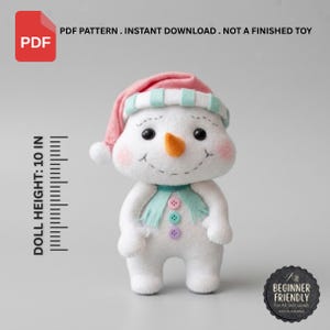 May include: A white felt snowman doll with a pink and teal striped hat, an orange carrot nose, and a teal scarf with three small buttons. The doll has pink cheeks and a stitched smile. Text indicates a PDF pattern with a 10 inch doll height.