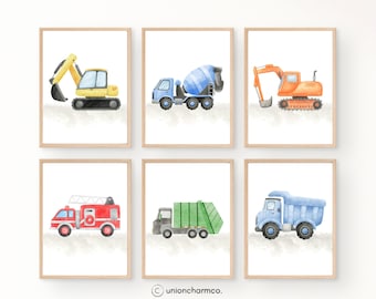 May include: Six framed watercolor prints featuring construction vehicles. The prints showcase a yellow excavator, a blue cement mixer, an orange excavator, a red fire truck, a green garbage truck, and a blue dump truck. Each print is set against a neutral background.
