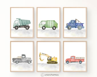 May include: Set of six framed watercolor prints featuring various construction vehicles. Includes a dump truck, garbage truck, pickup truck, excavator, and a red pickup truck. Each print has a white background with a light gray watercolor wash.