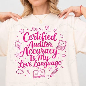 May include: An ivory t-shirt featuring hot pink text that reads Certified Auditor Accuracy Is My Love Language. The design includes small graphic icons of a lightbulb, a laptop, a pencil, stars, hearts, and an open book surrounding the text.