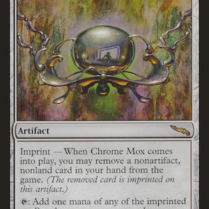 May include: A Chrome Mox trading card featuring a central metallic sphere suspended by silver chains against a textured green and brown background. The card text includes the name Chrome Mox, the artifact type, and game rules.
