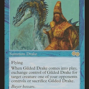 May include: A blue Magic: The Gathering trading card titled Gilded Drake. The illustration depicts a blue-scaled drake and a figure in a tall hat. The card text includes Flying, the exchange ability, and the flavour text Buyer beware.