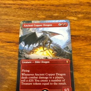 May include: A Magic: The Gathering trading card titled Ancient Copper Dragon. The card features a copper-coloured dragon perched on a pile of gold treasure. The text box displays the creature type Elder Dragon, the ability Flying, and game rules.