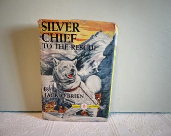 May include: Vintage book cover for "Silver Chief to the Rescue" by Jack O'Brien. The cover features a white dog with a red collar in a snowy mountain scene. The title is in large, bold letters.