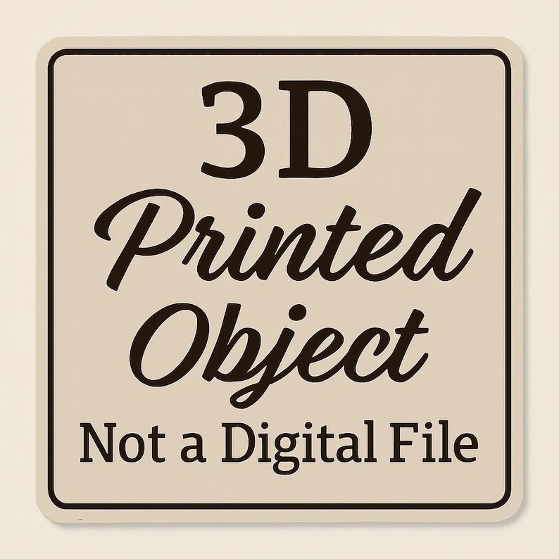 May include: A square sign with rounded corners, featuring the text "3D Printed Object" in a mix of bold and cursive fonts. Below, the text "Not a Digital File" is printed in a simple font. The sign has a cream background with a dark brown border.