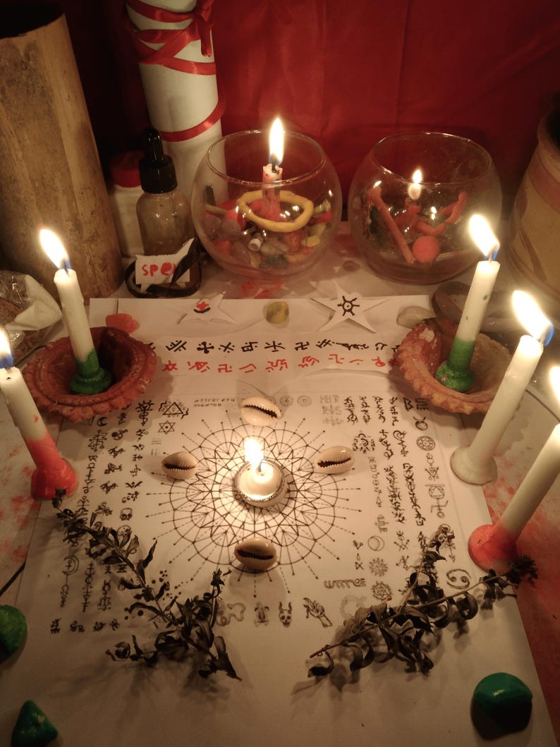 May include: A white paper sheet featuring intricate black geometric patterns, symbols, and text, surrounded by six lit white candles in clay holders and glass bowls. Four cowrie shells are placed on the paper, with dried plant sprigs nearby.