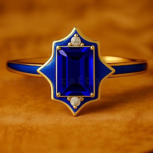 May include: A gold ring featuring a rectangular, deep blue gemstone. The gemstone is set within a blue and gold decorative frame, with small diamond accents. The ring band is also blue and gold.