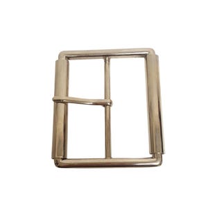 May include: A rectangular silver-toned metal belt buckle featuring a smooth, polished finish. The buckle consists of a sturdy outer frame with rounded corners, a central vertical bar for structural support, and a movable prong attached to one side.