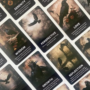 May include: A set of oracle cards with dark, atmospheric imagery of ravens and natural elements. Each card displays a word such as "Courage" or "Love" alongside a brief explanation. The cards are intended for spiritual insight and personal growth.