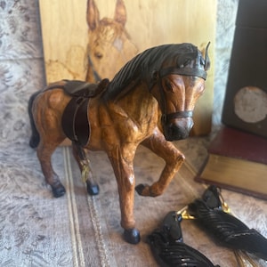 Vintage leather wrapped horse figurine with saddle