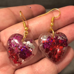 Red and pink resin earrings with glitter