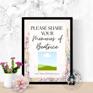 Könnte beinhalten: Ein gerahmtes Schild mit dem Text „PLEASE SHARE YOUR Memories of Beatrice“ und Platz für ein Foto. Das Schild ist mit floralen Elementen und einem kleinen Bild einer Landschaft verziert. Ein kleiner weißer Topf mit rosa Blumen befindet sich im Vordergrund.
