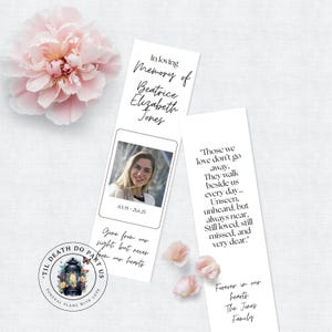 May include: Two memorial bookmarks with text and a photo of a woman, Beatrice Elizabeth Jones. One bookmark reads "In loving Memory of Beatrice Elizabeth Jones" and the other reads "Those we love don't go away..." A pink flower is in the background.