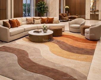 May include: A large area rug with a wavy design in shades of beige, brown, and orange. The rug is placed in a living room setting with a sectional sofa, armchairs, and a coffee table. The rug's design adds a modern touch to the room.