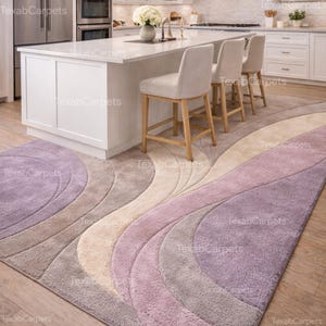 This image features a modern kitchen styled with a hand tufted abstract rug, adding softness and comfort underfoot.