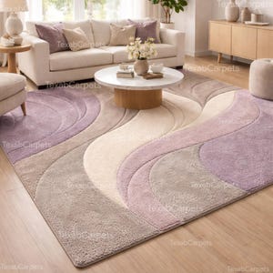 This image shows a modern living room styled with a hand tufted abstract wavy rug in lavender, beige, and grey tones, creating a calm and elegant focal point.