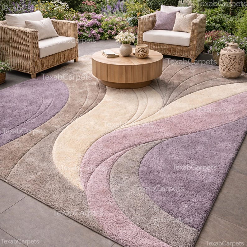 This image shows a covered garden seating area styled with a hand tufted abstract rug in soft neutral tones.