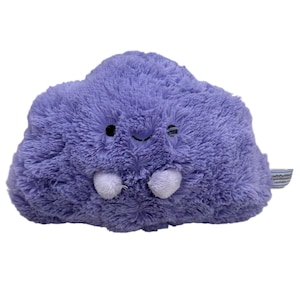 May include: A plush, lavender-colored cloud-shaped toy with a smiling face and small white appendages. The toy has a soft, fuzzy texture and black embroidered eyes. A small tag is attached to the side.
