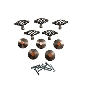 May include: A set of five dark metal cabinet knobs with a twisted cage design, five circular dark metal knobs with copper-colored centers, and ten matching metal mounting screws arranged in a group on a plain white background.