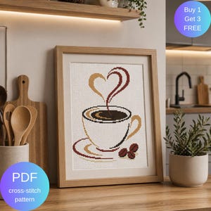 Könnte beinhalten: Ein gerahmtes Kreuzstichmuster einer Kaffeetasse mit Dampf in Herzform. Die Tasse ist weiß mit braunen Akzenten, der Dampf ist braun und goldfarben. Der Text "PDF cross-stitch pattern" befindet sich in einem blauen Kreis.
