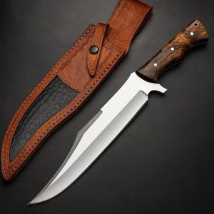 May include: A large hunting knife with a polished steel blade and a dark wood handle. The knife is paired with a brown leather sheath with a black textured accent. The sheath has a snap closure.