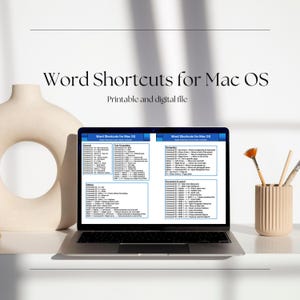May include: A laptop displays "Word Shortcuts for Mac OS" with a list of commands. The screen is open on a white surface, next to a beige vase and a small container with paintbrushes. The text "Printable and digital file" is above the laptop.